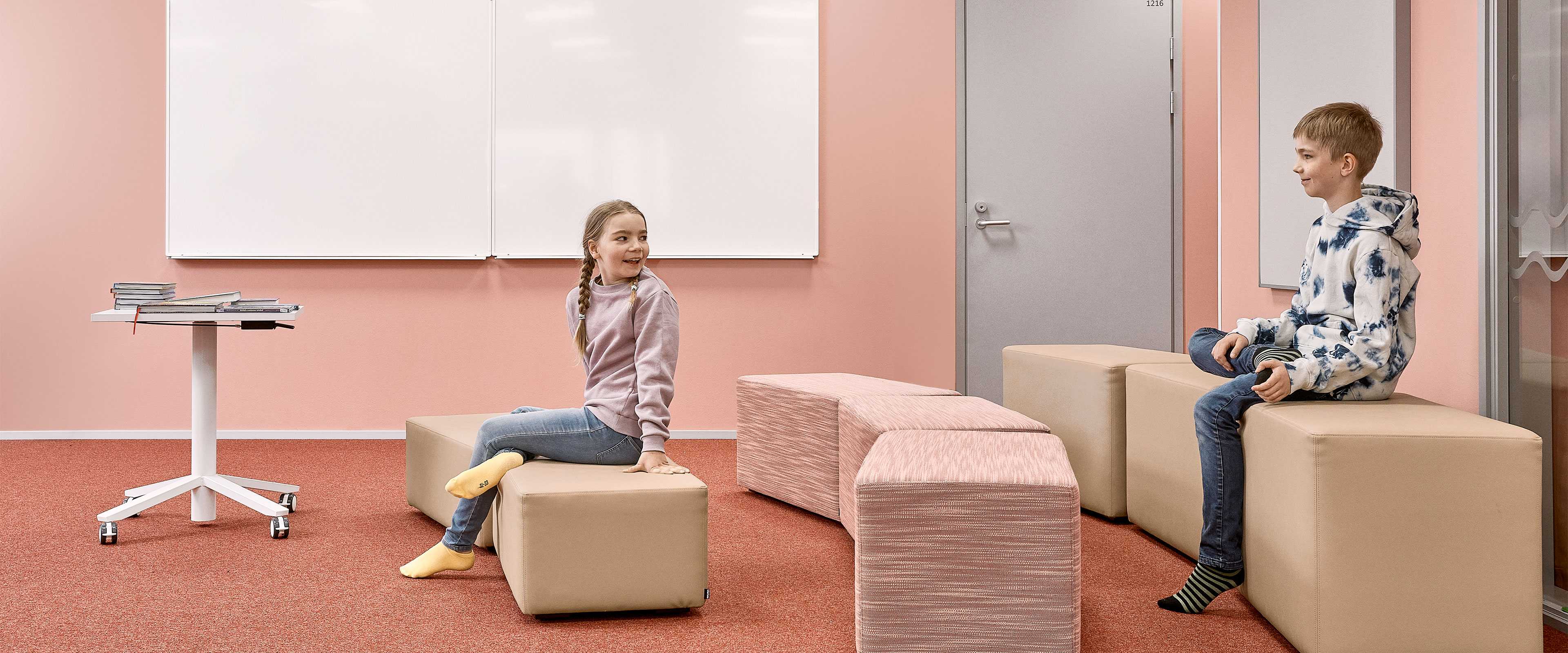 Two pupils sitting on Bit stools